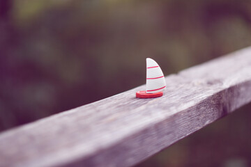 toy boat on the railing in the park, dreams of the sea and dreams of summer