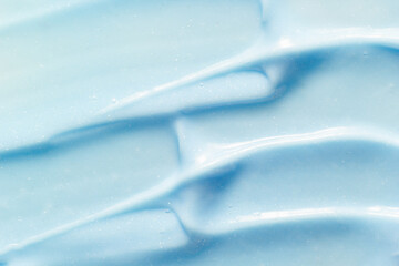 Toothpaste texture. Blue color abrasive dental paste smudged close up