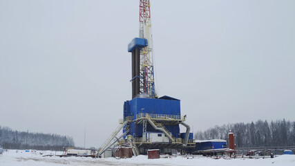 Oil and Gas Drilling Rig in winter. Oil drilling rig operation on oil platform in oil and gas...