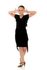 A cheerful little girl is dancing.The concept of a school of dan