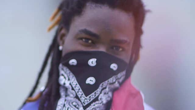 Blurred image of protesting activist in mask in street. Rebellion, having fun, modern protest. Blurry view. Slow motion