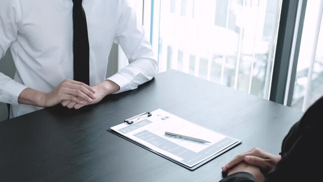 Office executives are interviewing job applicants in the meeting room.