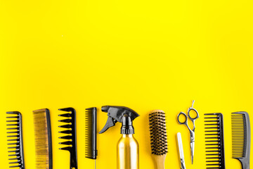 Hairdresser tools. Flat lay on yellow background top view copy space