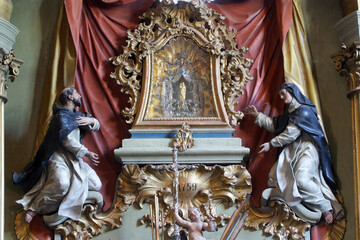 Saints Dominic and Catherine of Siena kneel in front of the statue of the Virgin with Child on the high altar in the Church of Our Lady of Jerusalem at Trski Vrh in Krapina, Croatia