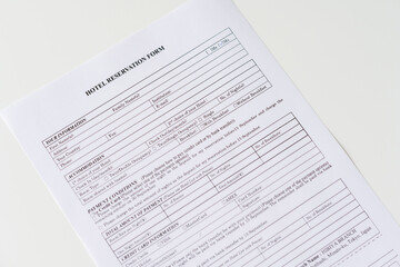 Obraz premium Hotel reservation form on the table at the office. Rental agreement apartment, house. Close up. Selective focus