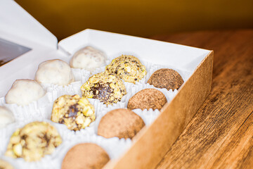 different round candies with chocolate, nuts and coconut