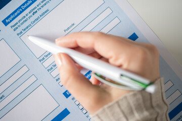 Woman customer filling property reservation form, post tenancy contact address. Rental agreement apartment, house. Close up. Selective focus.