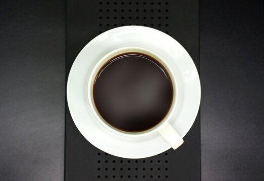 Black coffee in a white mug on a black background for advertising background image Store decoration, brochures, books and more