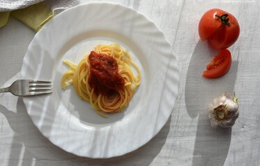 Delicious homemade spaghetti whit tomato sauce served at white plate/ Traditional Italian cuisine