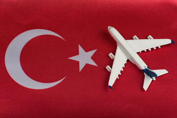 Turkey flag and toy airplane, close up. Resumption of flights after quarantine, opening borders