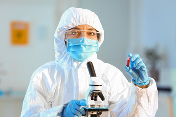 Scientist working with microscope in laboratory