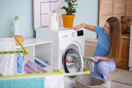 Young Woman Doing Laundry At Home