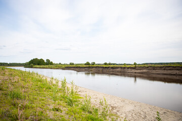 View of the Tara river, Omsk region, Siberia, Russia. Surroundings of the Siberian expanses. Picturesque view on the steep Bank of the river.