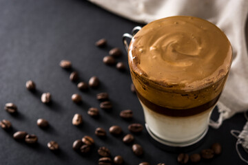 Creamy iced dalgona coffee on black background. Copy space	
