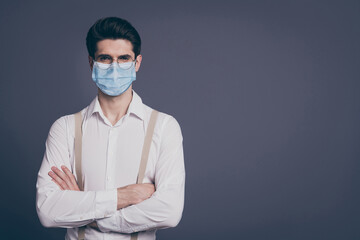 Close-up portrait of his he nice attractive imposing elegant man macho wearing reusable gauze mask stop contagious cov ncov influenza folded arms isolated on grey pastel color background