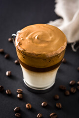 Creamy iced dalgona coffee on black background	
