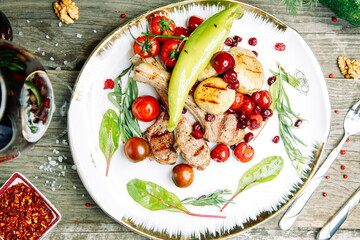 Restaurant dish on a wooden background. Azerbaijani shish kebab and grilled ribs.