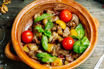 Beef stew, restaurant dish. Vegetable stew with beef in a clay bowl.