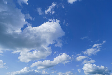 Naklejka na ściany i meble Beautiful bright blue sky and white fluffy clouds