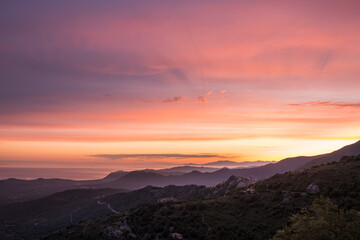 Dawn breaking over Speloncato and coastline of Corsica