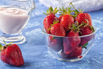 Fresh strawberries with freshly prepared yogurt on the table