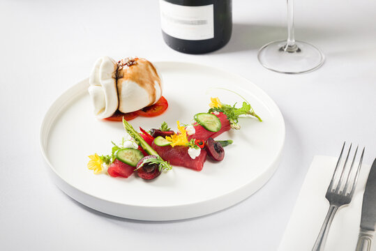 Burrata on a plate with salad and wine