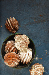 Delicious sweet dessert for a snack. Chocolate cookies sprinkled with powdered sugar top view with space for text