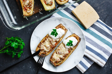Homemade zucchini stuffed with meat, mushrooms and cheese. Squash boats. Loaded zucchini. Diet menu. Side view, top view.