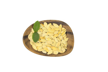 Pumpkin seeds, on a white background.White seeds, for cooking healthy food. Vitamin product in a brown wooden plate.