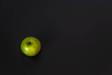 Green apple in black background.Flat lay.Healthy concept
