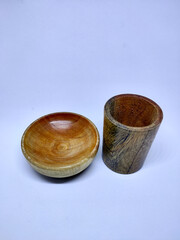 Traditional wooden bowl and cup isolated on white background. Selective focus.