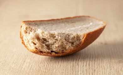 Fresh sliced bread on a wooden background.