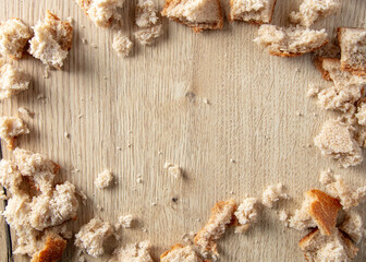 Bread crumbs on a wooden table.