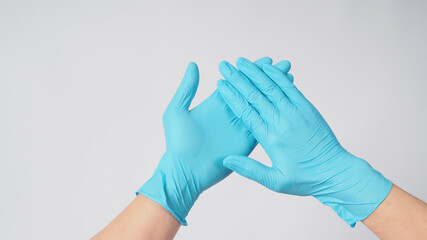 Two hand with blue latex gloves on white background.