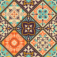 Seamless colorful patchwork tile with Islam, Arabic, Indian, Ottoman motifs. Majolica pottery tile. Portuguese and Spain decor. Azulejo. Ceramic tile in talavera style. Boho pattern