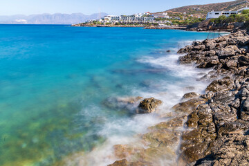 Waves hitting the rocks during hot summer day in Greece