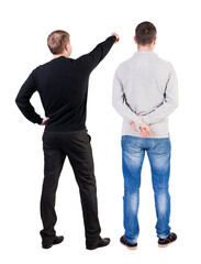 Back view of two man in sweater pointing.