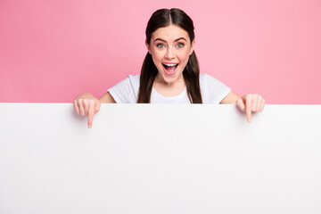 Portrait of her she nice attractive lovely charming glad amazed cheerful cheery girl showing copy empty blank space board promotion presentation isolated over pink pastel color background