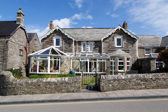Tintagel, Cornwall, UK: April 14, 2014: A traditionally built, double fronted stone house with two added conservatories. A beautiful example of the characteristic houses in rural Cornwall. 