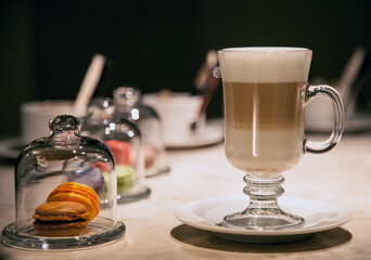 A cup of latte and a sweet dessert are on the table