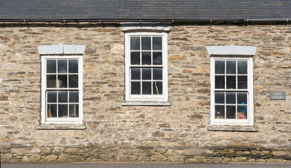 Fototapeta na wymiar Building with three sash Georgian style windows in Felindre Farchog, near Newport. Pembrokeshire, Wales. UK