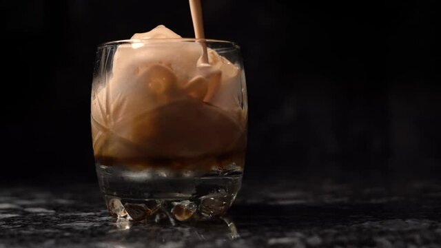 iced coffee in glass bottom with black background