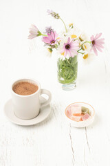 coffee and Turkish delights on table with flowers