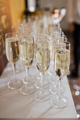 Glasses of champagne on the table. Vertical photo, holiday.