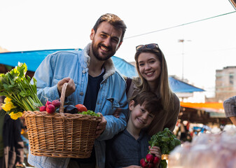 Fototapeta premium Family of three buying groceries and vegetables for their home