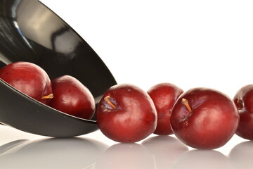 Juicy, tasty, organic red plum, close-up, on a white background.