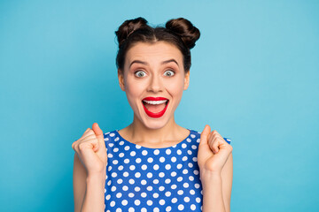 Close up photo of funny excited lady see low shopping prices proposition advertisement addicted shopper raise fists wear dotted white blouse isolated blue color background