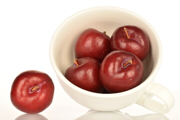 Juicy, tasty, organic red plum, close-up, on a white background.