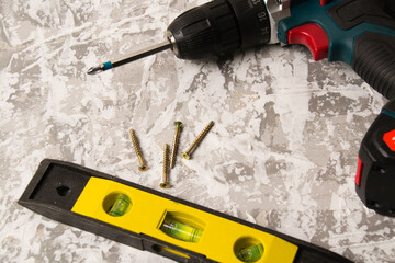 Dowel screwdriver and level on concrete. Concept advertising construction companies