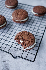 Bitten whoopie pies on a baking grid.